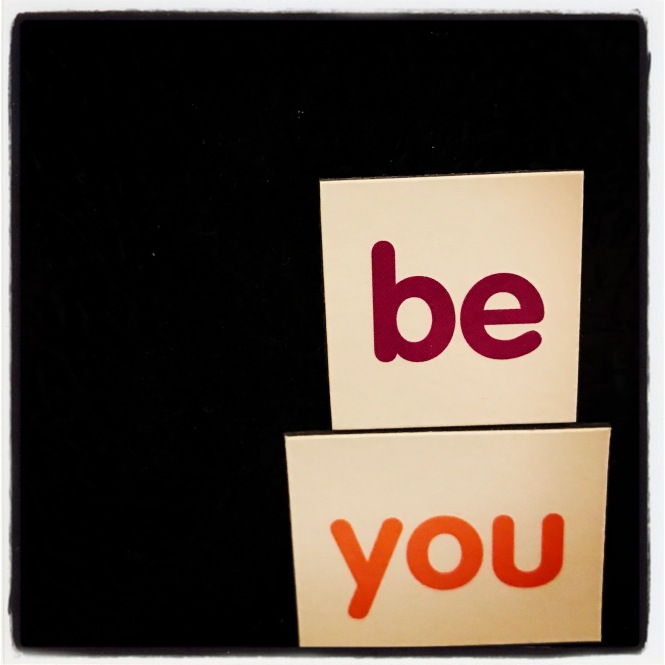 Square magnets spell out, "be you."